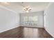 Sunlit living room with hardwood floors, ceiling fan, and a large window for natural light at 4333 Dunwoody Park # 1211, Atlanta, GA 30338
