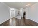 Open-concept living area showcasing the hardwood floors and a view into the kitchen at 4333 Dunwoody Park # 1211, Atlanta, GA 30338