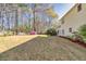 Spacious backyard with patio set, well-maintained lawn, mature trees and lush landscaping at 735 Ambur Cove Way Nw, Lawrenceville, GA 30043