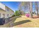 Spacious backyard with a patio set, well-maintained lawn, mature trees and lush landscaping at 735 Ambur Cove Way Nw, Lawrenceville, GA 30043