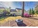 Spacious backyard with patio set, bench, firepit, well-maintained lawn, mature trees and lush landscaping at 735 Ambur Cove Way Nw, Lawrenceville, GA 30043