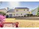 Spacious backyard with patio set, bench, well-maintained lawn, mature trees and lush landscaping at 735 Ambur Cove Way Nw, Lawrenceville, GA 30043