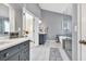 Luxurious bathroom with double vanities, marble floors, soaking tub and a view into the primary bedroom at 735 Ambur Cove Way Nw, Lawrenceville, GA 30043