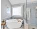 Modern bathroom with a soaking tub, glass-enclosed shower, gray subway tile and a serene spa-like atmosphere at 735 Ambur Cove Way Nw, Lawrenceville, GA 30043