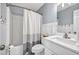 Clean bathroom with a modern vanity, sink, toilet, shower and tub combination with a stylish shower curtain at 735 Ambur Cove Way Nw, Lawrenceville, GA 30043