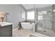 Contemporary bathroom showcasing a glass shower, soaking tub, and sleek vanity for a luxurious feel at 735 Ambur Cove Way Nw, Lawrenceville, GA 30043