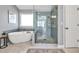Modern bathroom with freestanding tub, glass-enclosed shower, and stylish tile work for a spa-like experience at 735 Ambur Cove Way Nw, Lawrenceville, GA 30043