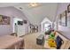 Spacious bedroom with dormer window, sofa, bed, dresser, bookshelves and sloped ceilings at 735 Ambur Cove Way Nw, Lawrenceville, GA 30043