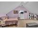 Cozy bedroom features a pitched roof, plush bed, dresser and television at 735 Ambur Cove Way Nw, Lawrenceville, GA 30043