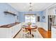 Cozy breakfast nook featuring a charming round table, wood floors, and lots of natural light at 735 Ambur Cove Way Nw, Lawrenceville, GA 30043