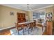 Elegant dining room with hardwood floors, stylish chandelier, and ample seating for entertaining at 735 Ambur Cove Way Nw, Lawrenceville, GA 30043