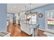 Kitchen island with granite countertop seating area, hardwood floors and view to the outdoors at 735 Ambur Cove Way Nw, Lawrenceville, GA 30043