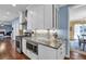 Beautiful kitchen boasts white cabinets, granite countertops, stainless appliances, and hardwood floors at 735 Ambur Cove Way Nw, Lawrenceville, GA 30043