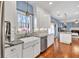 Bright, remodeled kitchen featuring hardwood floors, granite countertops, farmhouse sink, and stainless appliances at 735 Ambur Cove Way Nw, Lawrenceville, GA 30043