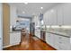 Bright kitchen features white cabinetry, stainless steel appliances, and hardwood flooring at 735 Ambur Cove Way Nw, Lawrenceville, GA 30043