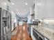 Modern kitchen featuring stainless steel appliances, granite countertops, and hardwood floors at 735 Ambur Cove Way Nw, Lawrenceville, GA 30043