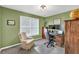 Cozy home office featuring a desk, dual monitors, a comfortable chair, and natural light from a large window at 735 Ambur Cove Way Nw, Lawrenceville, GA 30043
