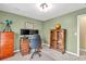 Charming home office featuring desk, dual monitors, globe, telescope, and natural light from a large window at 735 Ambur Cove Way Nw, Lawrenceville, GA 30043