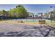 Well-maintained community tennis courts with benches and surrounding greenery at 735 Ambur Cove Way Nw, Lawrenceville, GA 30043