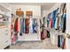 Spacious walk-in closet with custom shelving, hanging racks, and ample storage space for clothes and accessories at 735 Ambur Cove Way Nw, Lawrenceville, GA 30043