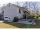 Back exterior featuring a garage and steps leading to a second story patio at 103 New Hood Rd, Stockbridge, GA 30281
