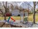 Backyard with a trellis swing and slide set for outdoor fun at 103 New Hood Rd, Stockbridge, GA 30281