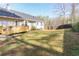 Expansive backyard featuring a wooden deck, lush green lawn, and a sturdy wooden fence, offering privacy at 103 New Hood Rd, Stockbridge, GA 30281