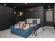 Cozy basement area with casual seating, shelving unit, and rustic decor, ideal for relaxation at 103 New Hood Rd, Stockbridge, GA 30281