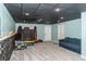 Finished basement including a fun trampoline and sofa; versatile space for entertainment or relaxation at 103 New Hood Rd, Stockbridge, GA 30281