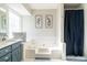Bright bathroom featuring a tub, shower, and vanity with a sink at 103 New Hood Rd, Stockbridge, GA 30281