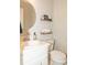Cozy bathroom featuring a vanity, round mirror, wood shelves, and a toilet at 103 New Hood Rd, Stockbridge, GA 30281