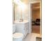 Bright bathroom with a white vanity setup, next to an open doorway revealing a Bedroom at 103 New Hood Rd, Stockbridge, GA 30281