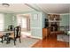 Inviting dining area with stylish chairs, hardwood floors, and a view into the living room at 103 New Hood Rd, Stockbridge, GA 30281