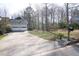Home featuring a paved driveway leading to a garage, set amidst a large, grassy front yard at 103 New Hood Rd, Stockbridge, GA 30281