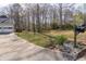 Home showcasing a spacious, well-kept lawn leading to a paved driveway and garage with a mailbox at 103 New Hood Rd, Stockbridge, GA 30281
