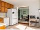 Traditional kitchen features wooden cabinets and views into a dining area at 103 New Hood Rd, Stockbridge, GA 30281