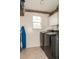 Functional laundry room with modern washer and dryer, paired with practical storage solutions at 103 New Hood Rd, Stockbridge, GA 30281