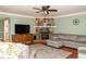 Cozy living room featuring a fireplace, built-ins, and a comfortable sectional sofa at 103 New Hood Rd, Stockbridge, GA 30281