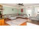 Spacious living room with a large sectional sofa, ceiling fan, and natural light at 103 New Hood Rd, Stockbridge, GA 30281