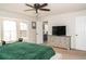 Bedroom with a large bed, green accent wall, natural light, and a dresser at 103 New Hood Rd, Stockbridge, GA 30281