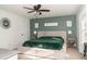 Comfortable bedroom with large bed, green accent wall, and plenty of natural light at 103 New Hood Rd, Stockbridge, GA 30281