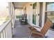 Inviting screened porch with rocking chairs, creating a relaxing outdoor space at 103 New Hood Rd, Stockbridge, GA 30281
