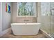 Elegant bathroom with soaking tub, large window, and a walk-in glass shower at 3141 Branford Ct, Marietta, GA 30062