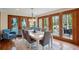 Bright dining room boasts hardwood floors, a modern chandelier, and deck access for seamless indoor-outdoor entertaining at 3141 Branford Ct, Marietta, GA 30062