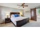 Comfortable bedroom with ceiling fan, dark wood furniture and sliding barn door to Primary bath at 3141 Branford Ct, Marietta, GA 30062