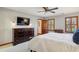 Comfortable bedroom featuring carpet, wood trim, a dresser and a mounted television at 3141 Branford Ct, Marietta, GA 30062