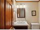 Stylish powder room with elegant lighting, a wood vanity, and modern fixtures at 3141 Branford Ct, Marietta, GA 30062
