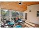 Inviting screened porch featuring a ceiling fan, wood floors, and outdoor seating with wooded view at 3141 Branford Ct, Marietta, GA 30062