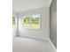 Bright bedroom with large windows offering a serene view of the outdoors and plush neutral carpeting at 3315 Hillshire Dr, Cumming, GA 30028