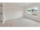 Well-lit bedroom with a large window, neutral carpeting, and serene outdoor views at 3315 Hillshire Dr, Cumming, GA 30028